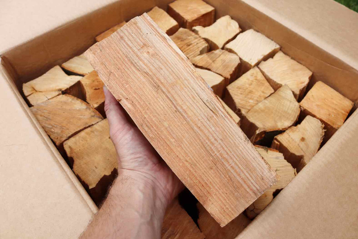 A Love Logs cardboard box containing hardwood logs