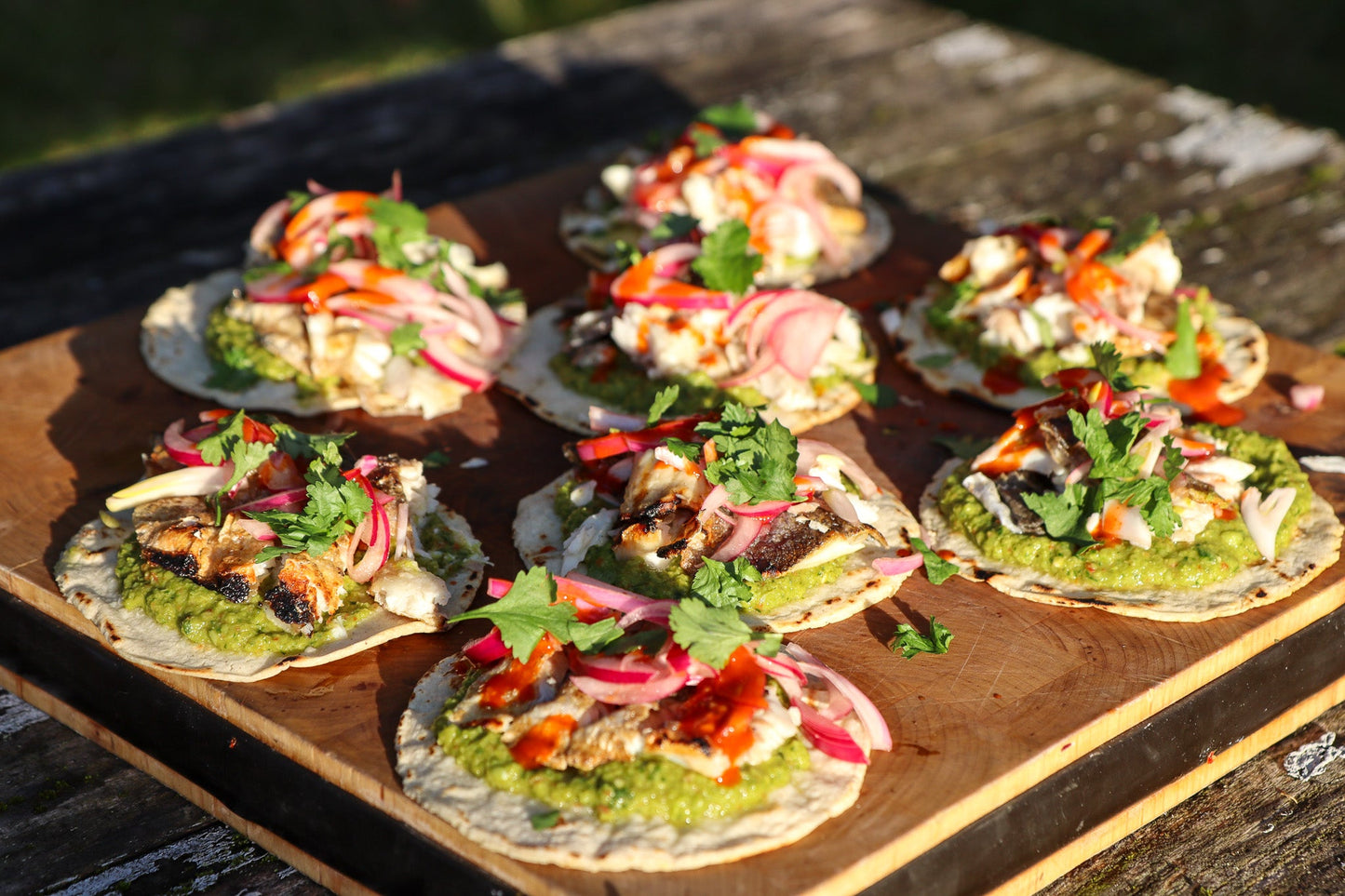 Grilled seabass tacos with "guacamopea" and pickled onions