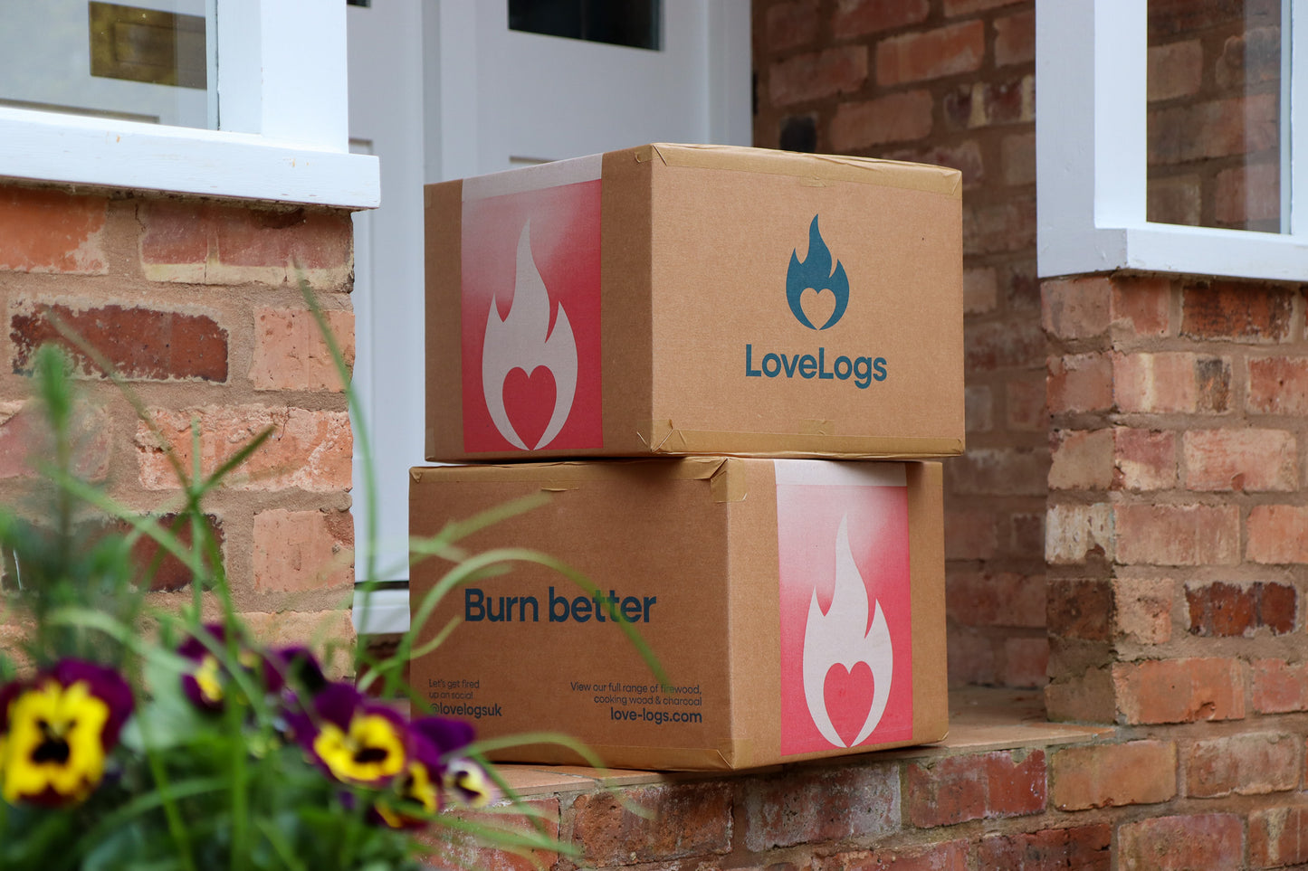 Boxes of Love Logs wood on porch step