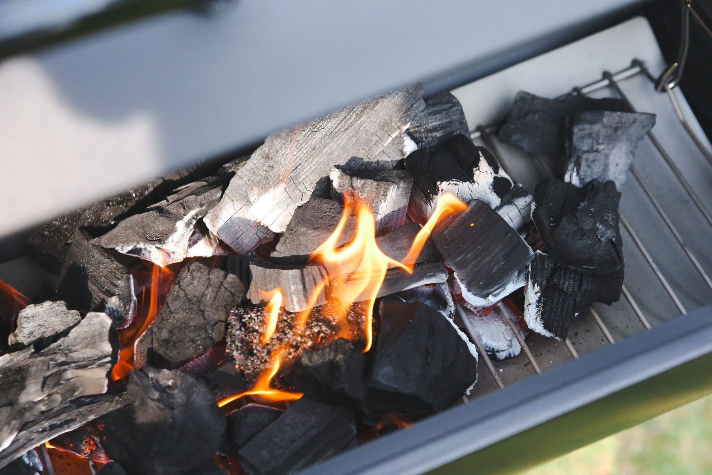 Love Logs sustainable British charcoal glowing in a grill