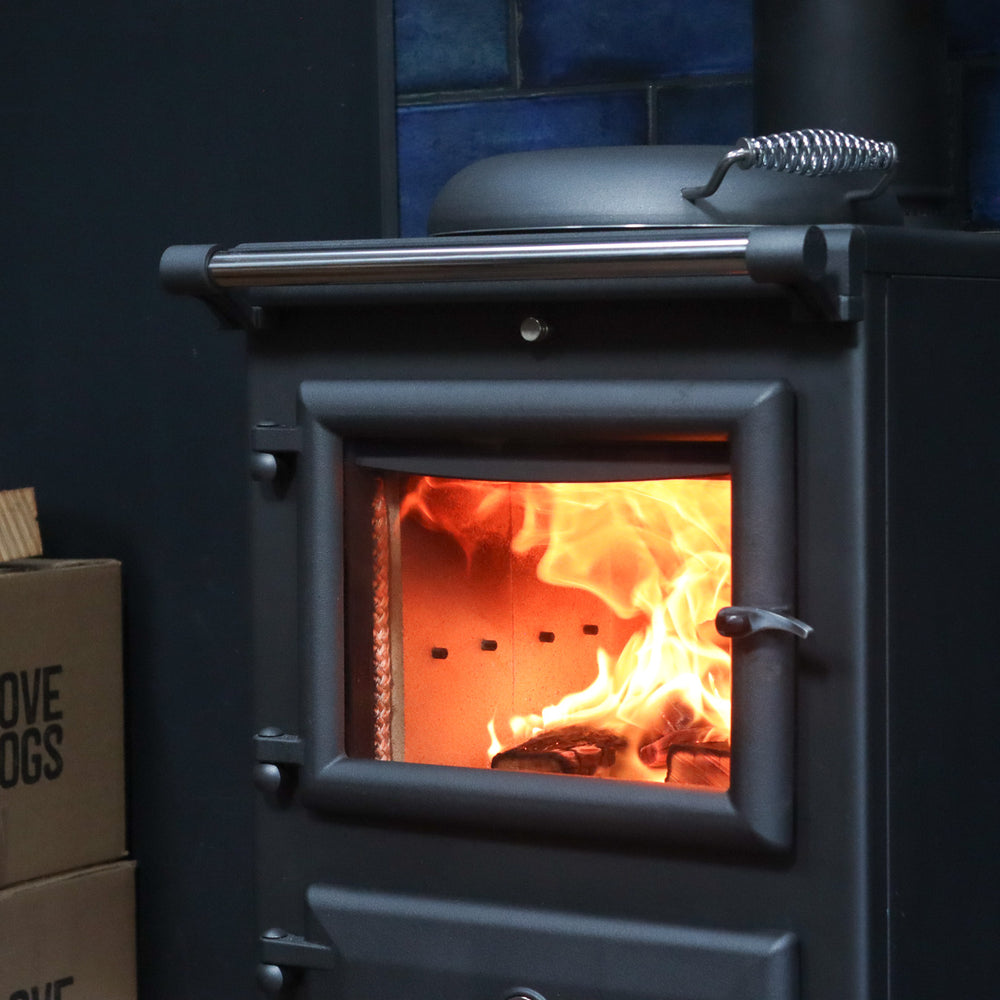 Roaring fire inside a log burner with Love Logs kiln-dried firewood in background