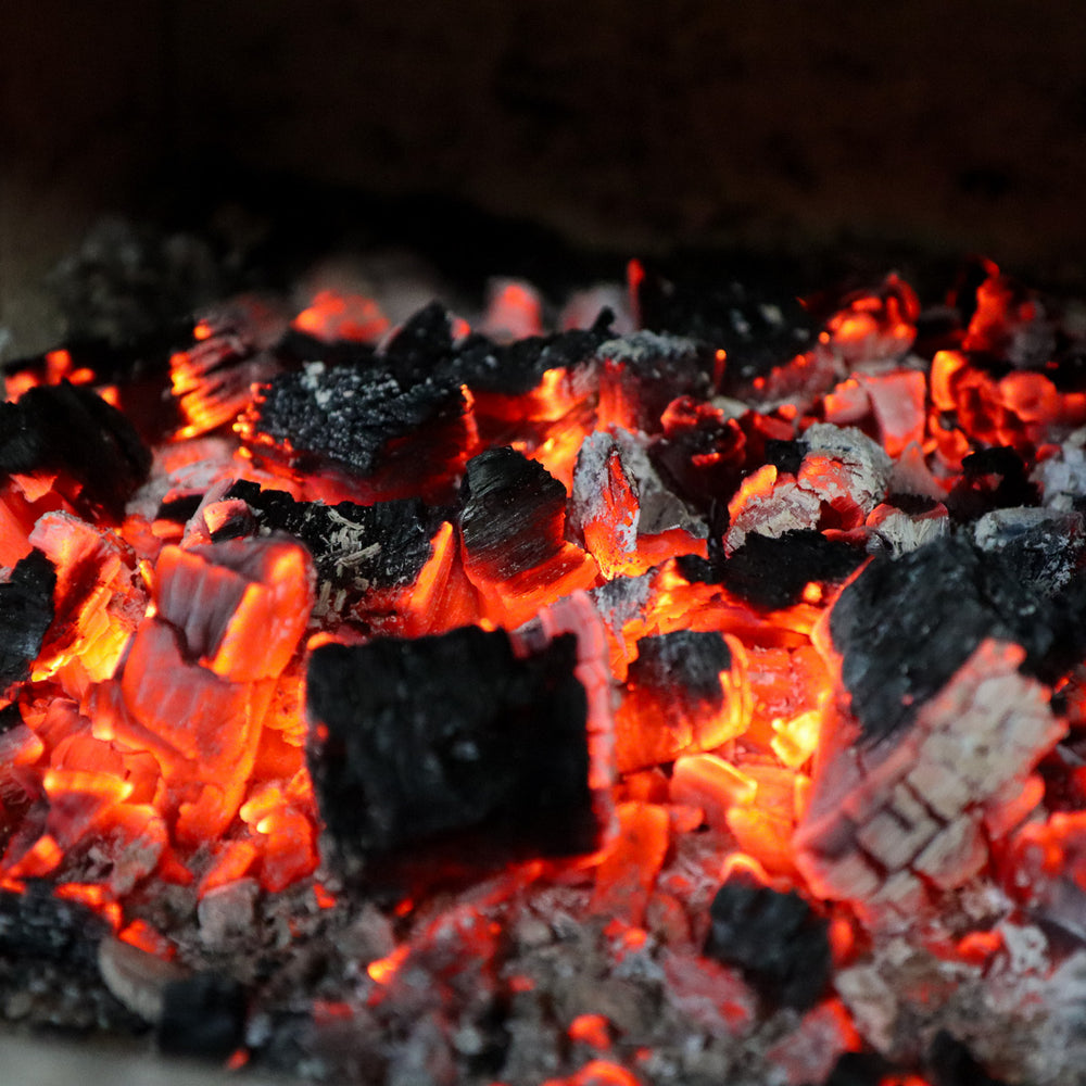 
                      
                        Long lasting Ready to Burn certified oak logs, burning to embers in log burner
                      
                    