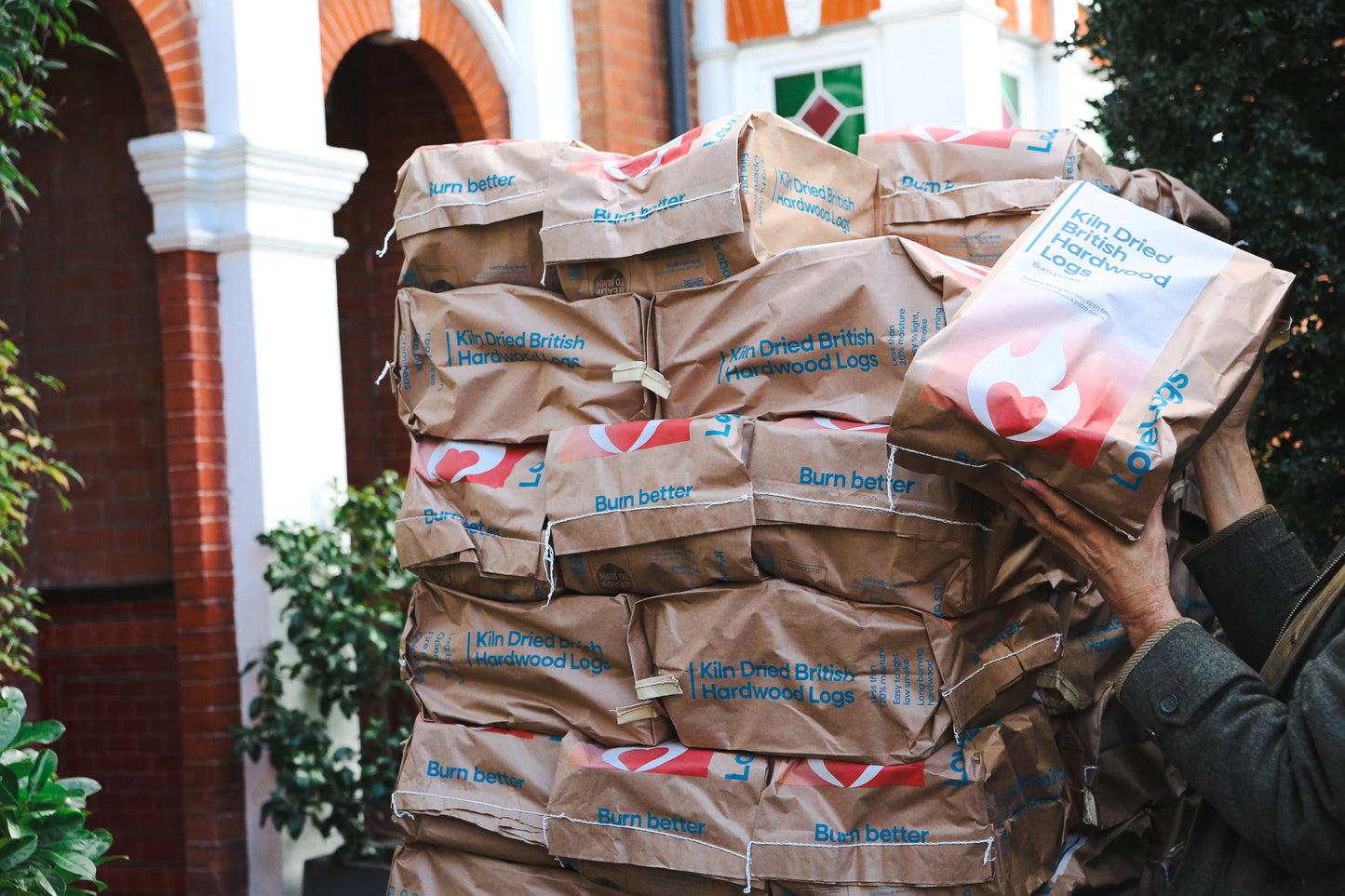 Unloading pallet of logs on driveway