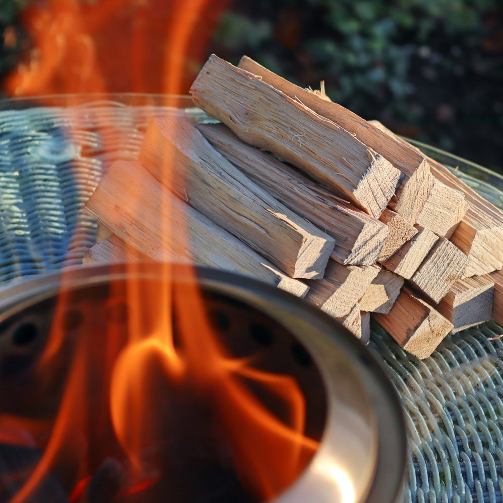 
                      
                        Love Logs Mini Fire Pit Wood burning cleanly in Mesa XL with wood stacked in the background
                      
                    