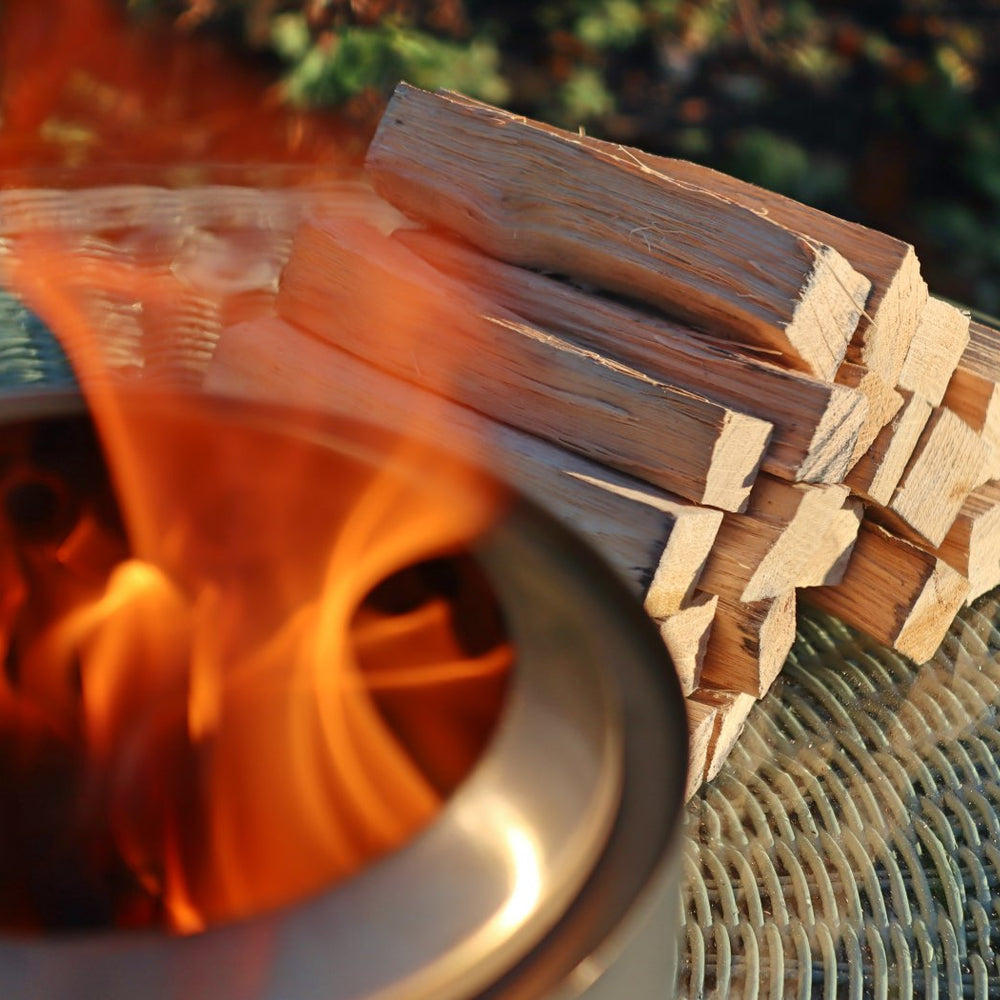 
                      
                        Love Logs Mini Fire Pit Wood burning cleanly in Mesa XL with wood stacked in the background
                      
                    