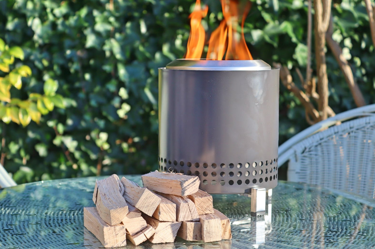 Love Logs Mini Fire Pit Wood next to Mesa XL